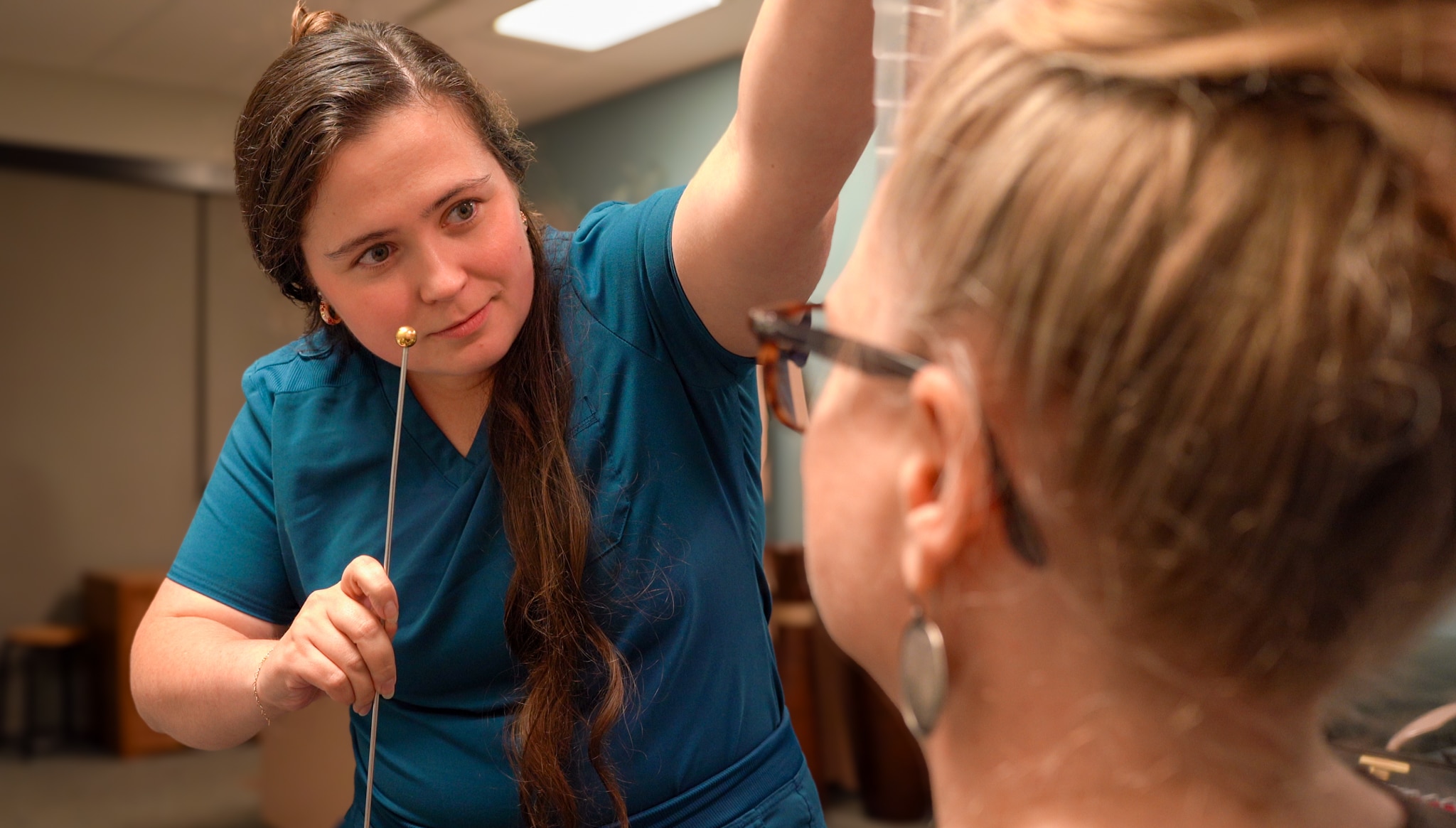 Dr. Kyle is using a tool to test a patient's eye tracking ability.